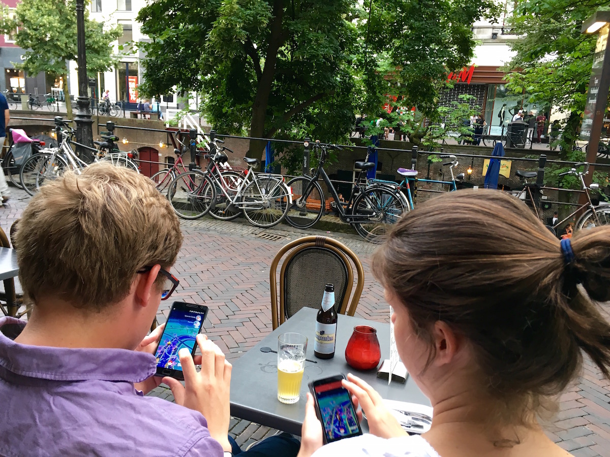 restaurant couple in Utrecht, Netherlands play over a beer